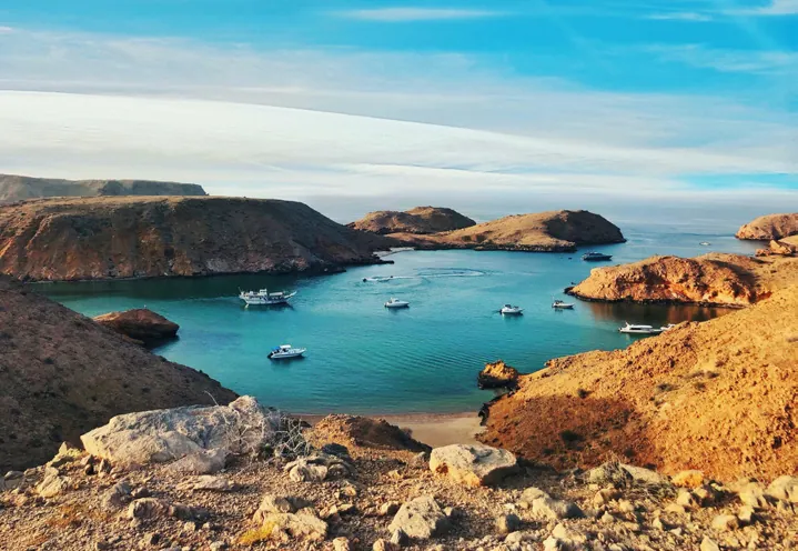 Boats anchored in a sheltered Omani bay