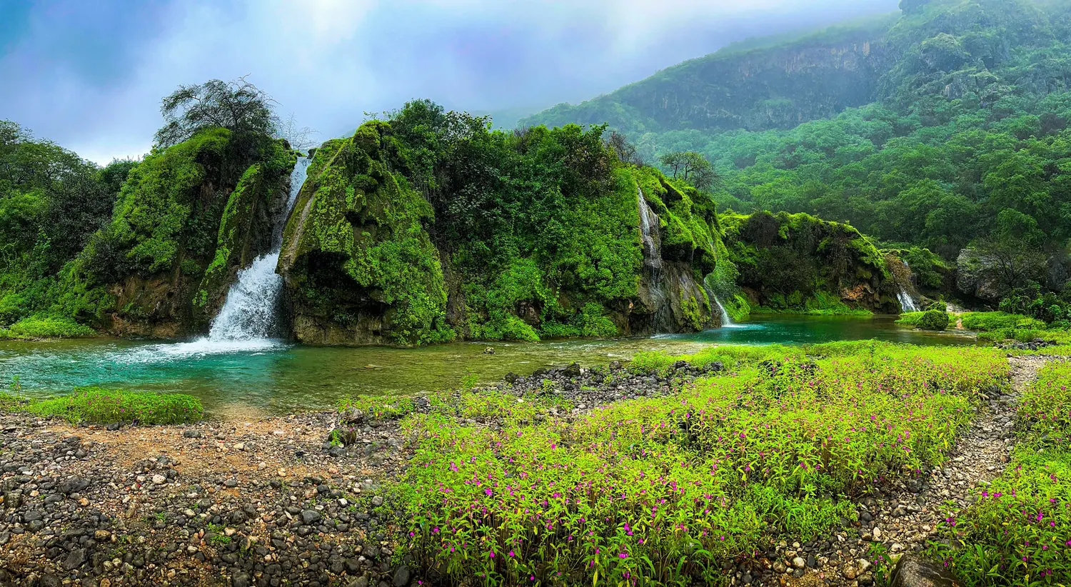 Waterfalls and green hills in Dhofar during khareef